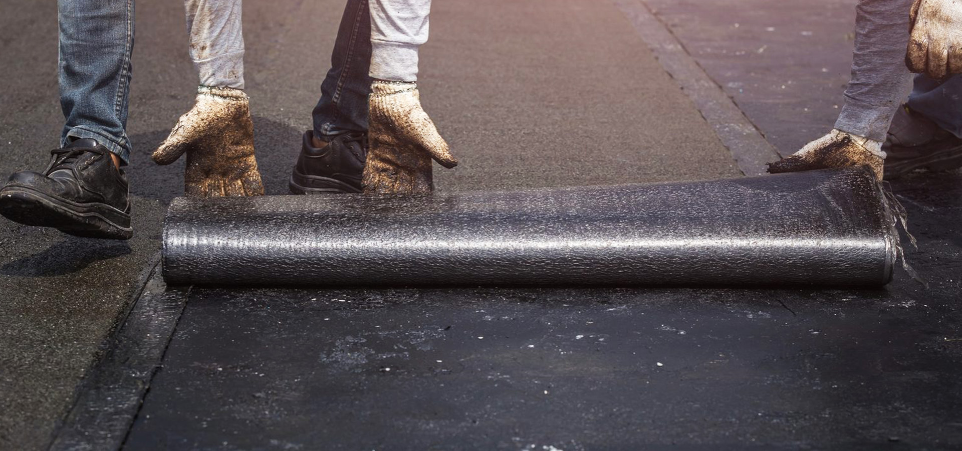 Workers applying Tar